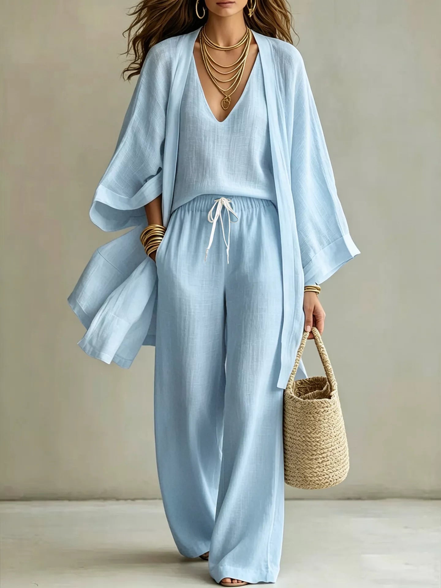 NEWYORKLISTED STYLE COLLECTION: Woman wearing a light blue outfit with a beige background