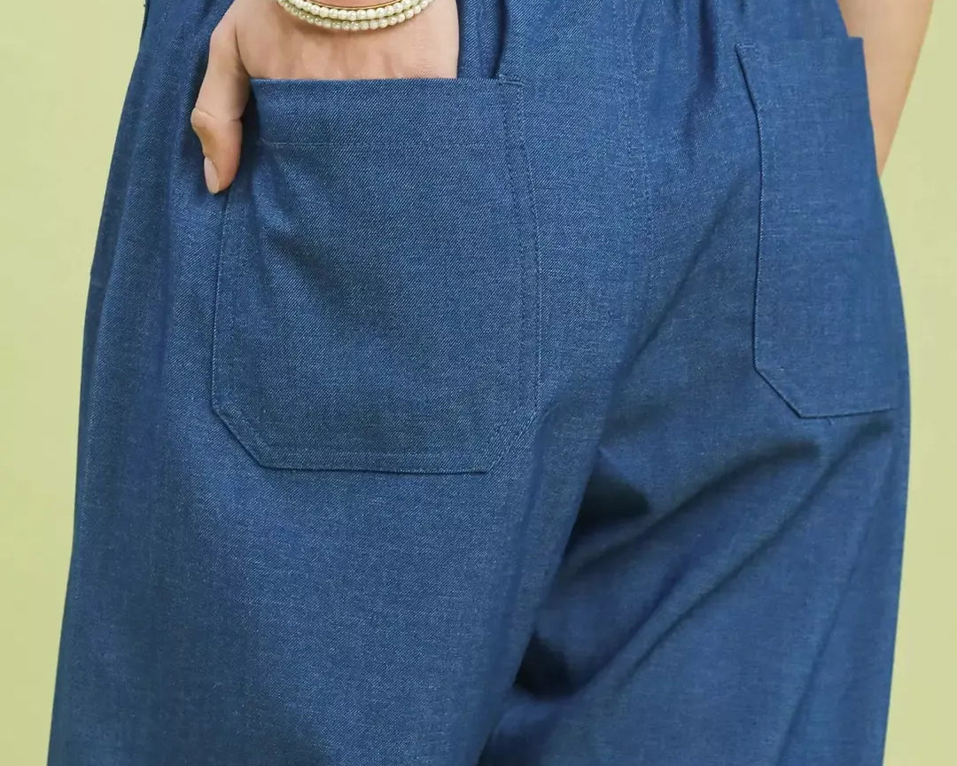 NEWYORKLISTED Style Collection: Blue denim pants with a light green background