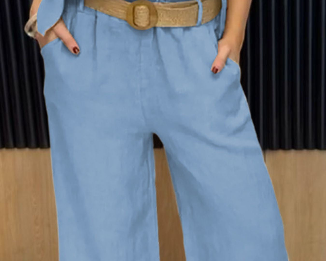 NEWYORKLISTED COMFORT COLLECTION: Person wearing a blue jumpsuit with a brown belt in an indoor setting