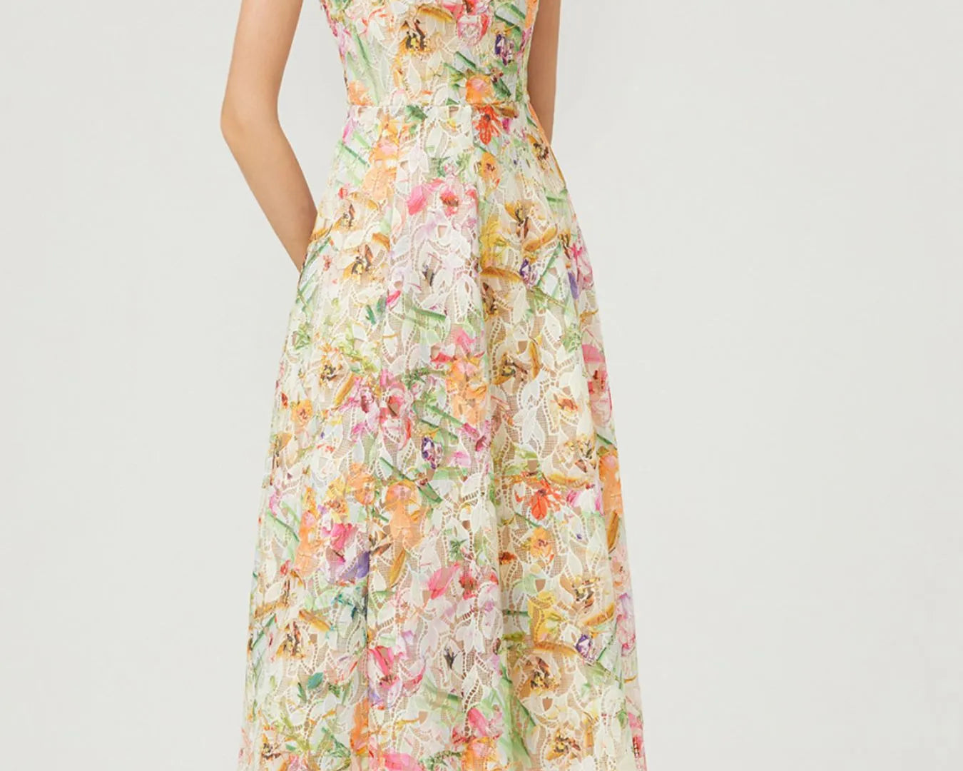NEWYORKLISTED STYLE COLLECTION: Woman wearing a floral dress on a white background