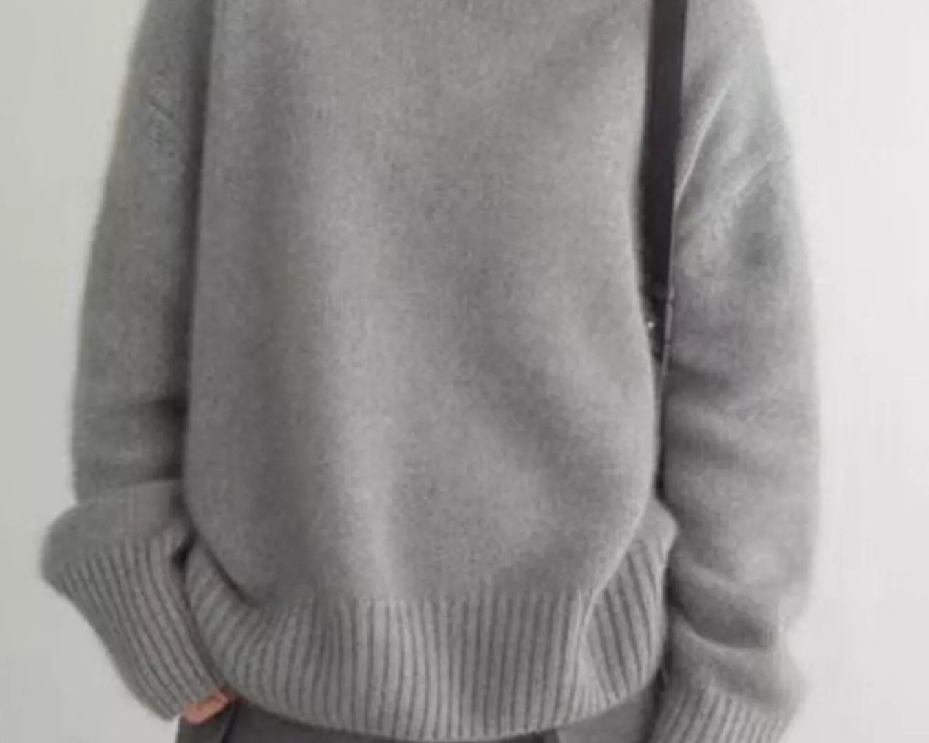 NEWYORKLISTED STYLE COLLECTION: Person wearing a gray turtleneck sweater and pants on a plain background