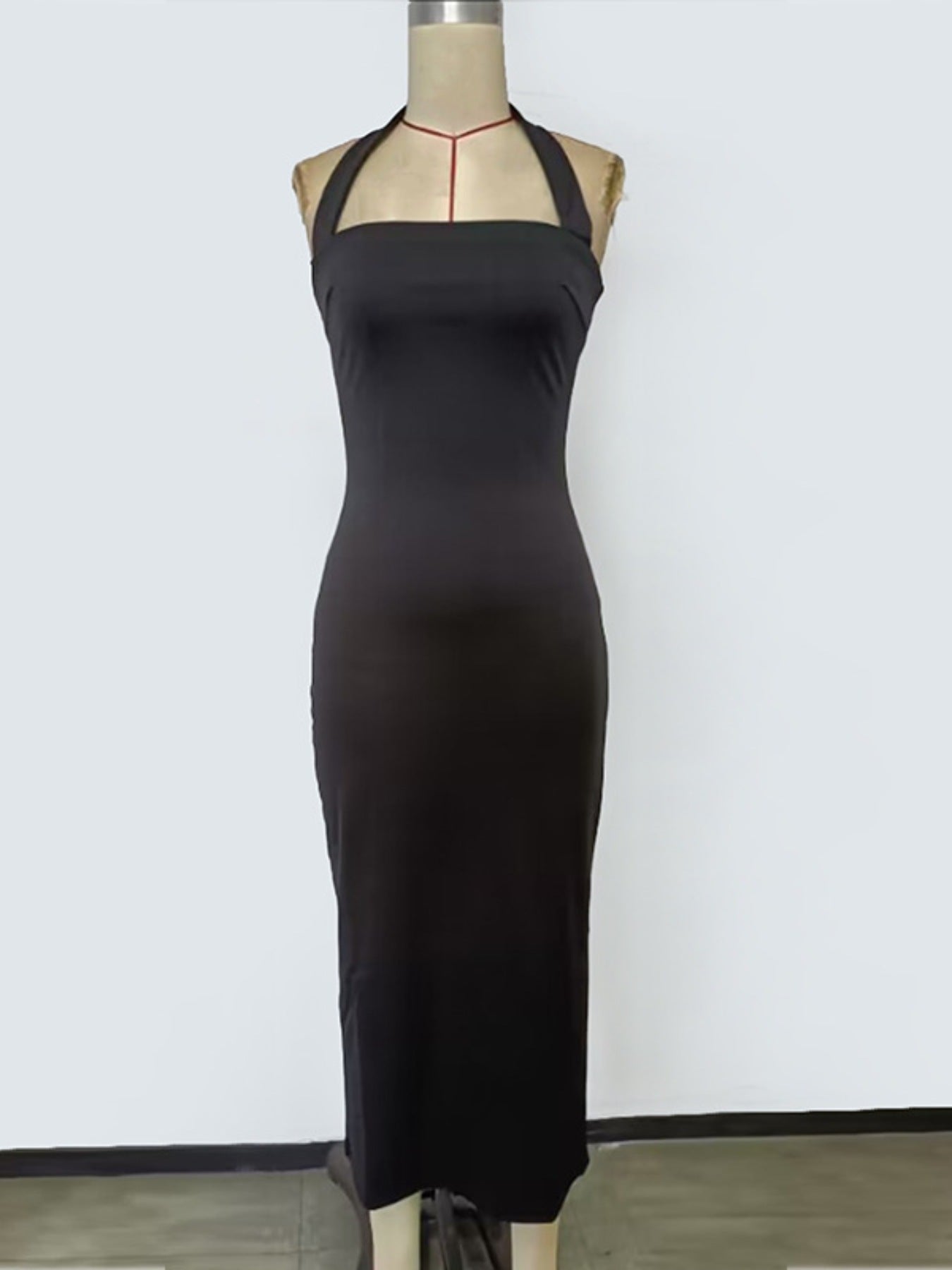 NEWYORKLISTED STYLE COLLECTION: Black dress on a mannequin against a white background