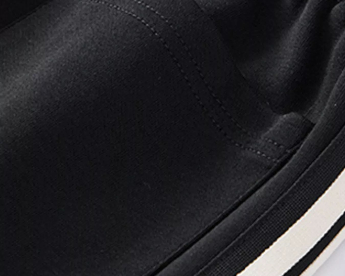 NEWYORKLISTED ATLAS MEN's COLLECTION: Close-up of black pants with a white stripe on a white background