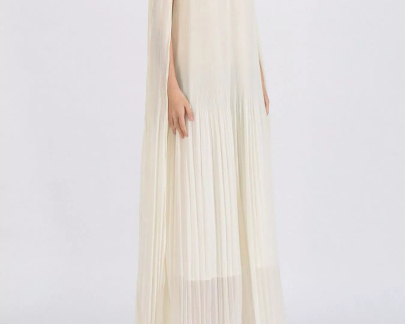 NEWYORKLISTED STYLE COLLECTION: Woman wearing a flowing off-shoulder dress with floral details on a white background