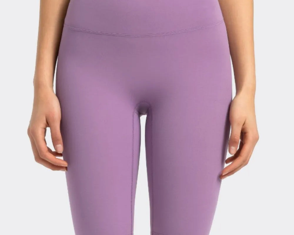 NEWYORKLISTED ACTIVEWEAR COLLECTION: Purple athletic shorts worn by a person on a white background