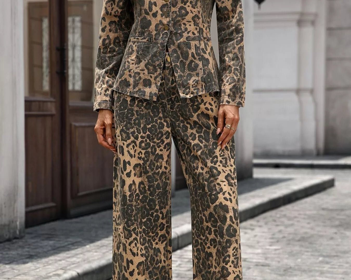 NEWYORKLISTED STYLE COLLECTION: Person wearing a leopard print suit standing on a street.