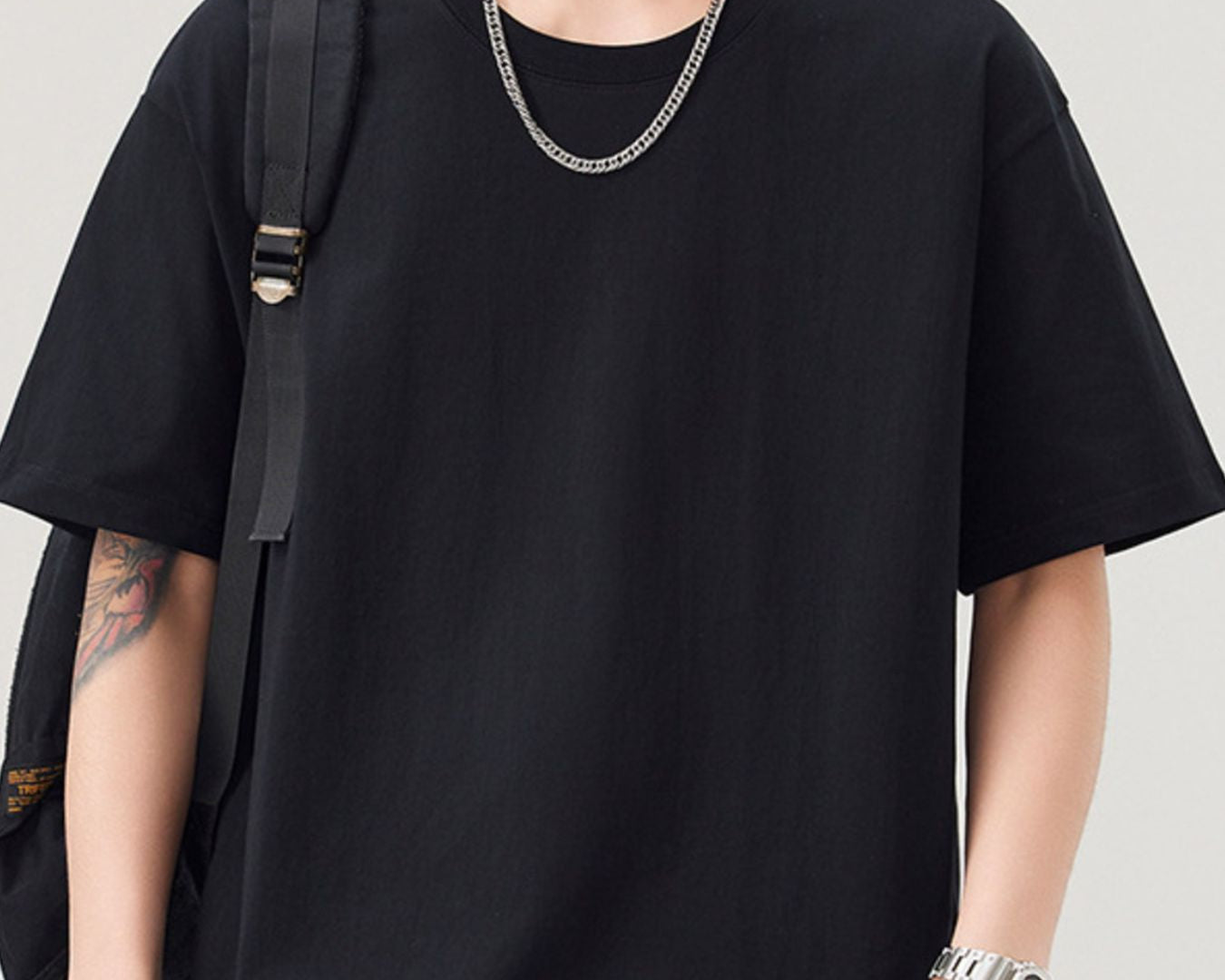 NEWYORKLISTED ATLAS MEN"S COLLECTION: Person wearing a black oversized t-shirt with a plain background