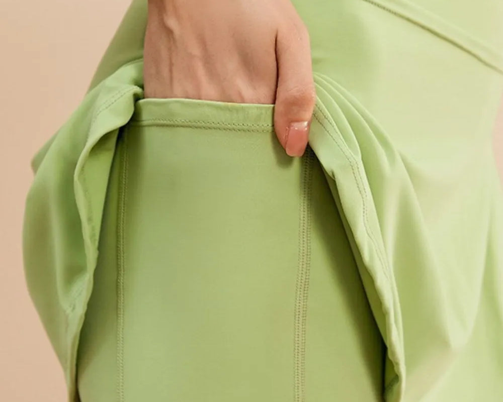 NEWYORKLISTED ACTIVEWEAR COLLECTION: Light green shorts being worn with a beige background