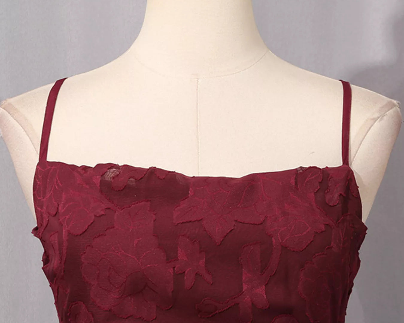 NEWYORKLISTED STYLE COLLECTION: Maroon lace dress on a mannequin with a gray background