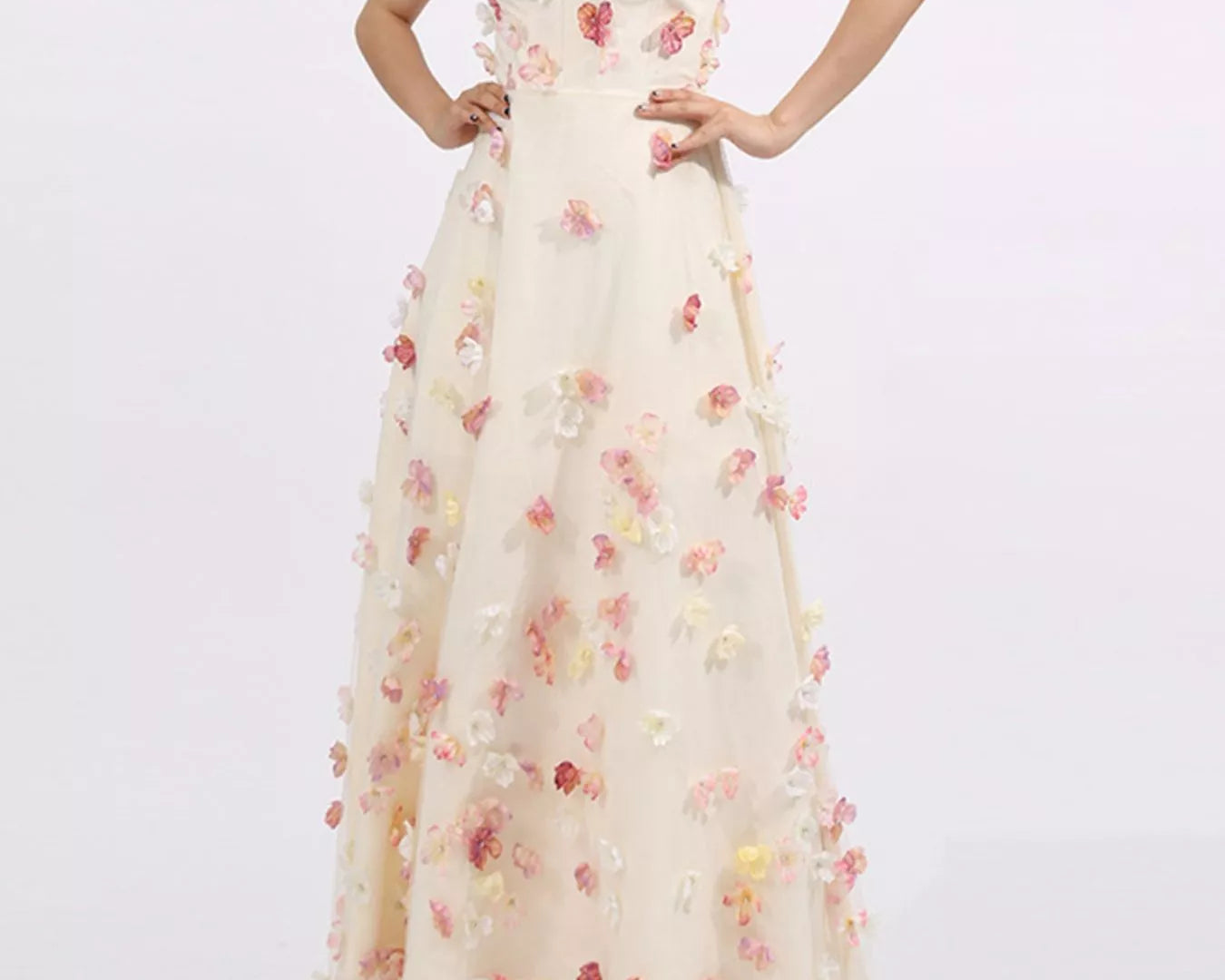 NEWYORKLISTED STYLE COLLECTION: Woman wearing a strapless floral gown on a white background