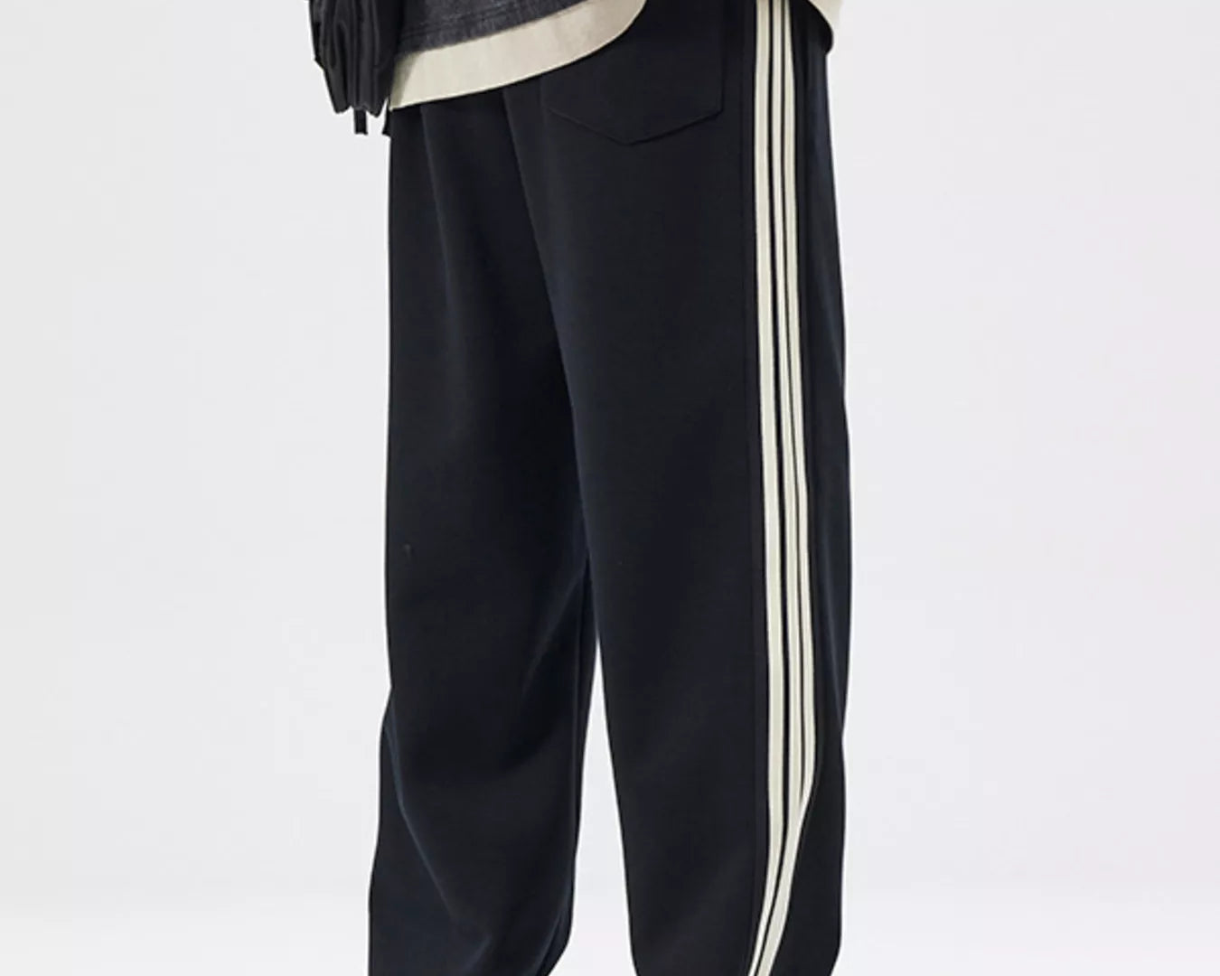 NEWYORKLISTED ATLAS MEN's COLLECTION: Person wearing black pants with white stripes on a white background