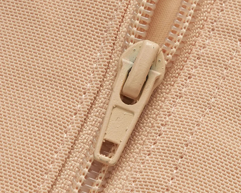 NEWYORKLISTED Intimate Apparel: Close-up of a beige zipper on a matching fabric background