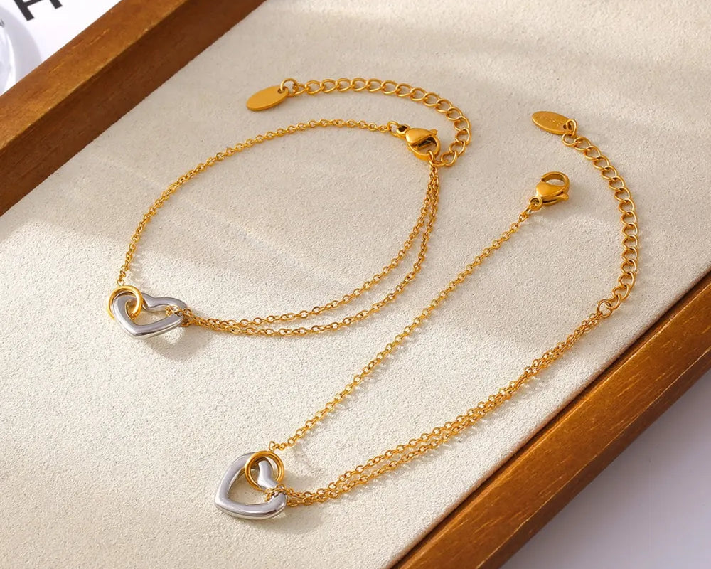 NEWYORKLISTED Valentine's Day Specials: Gold bracelet with heart-shaped charms on a wooden display box.