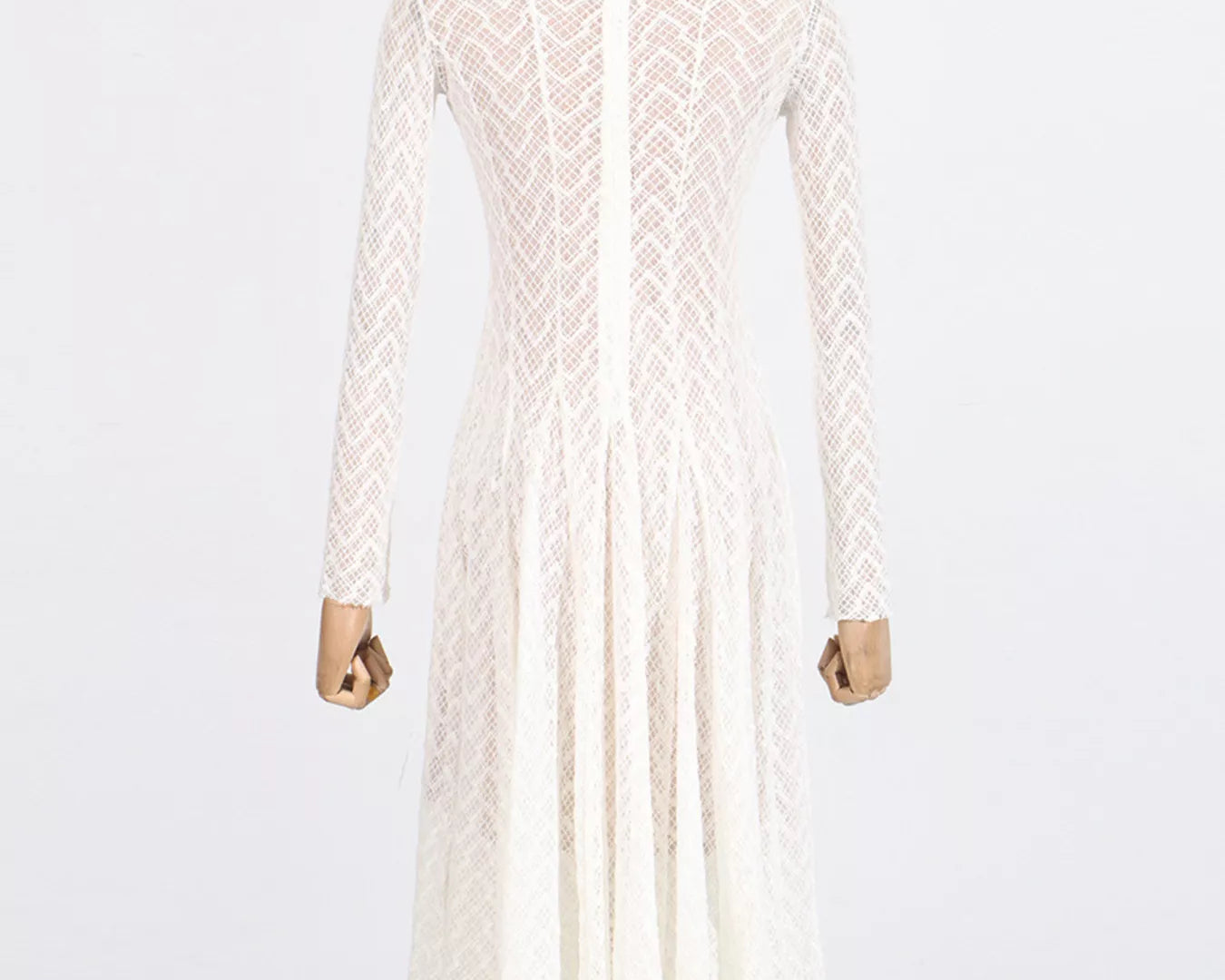 NEWYORKLISTED STYLE COLLECTION: White lace dress on a mannequin against a white background