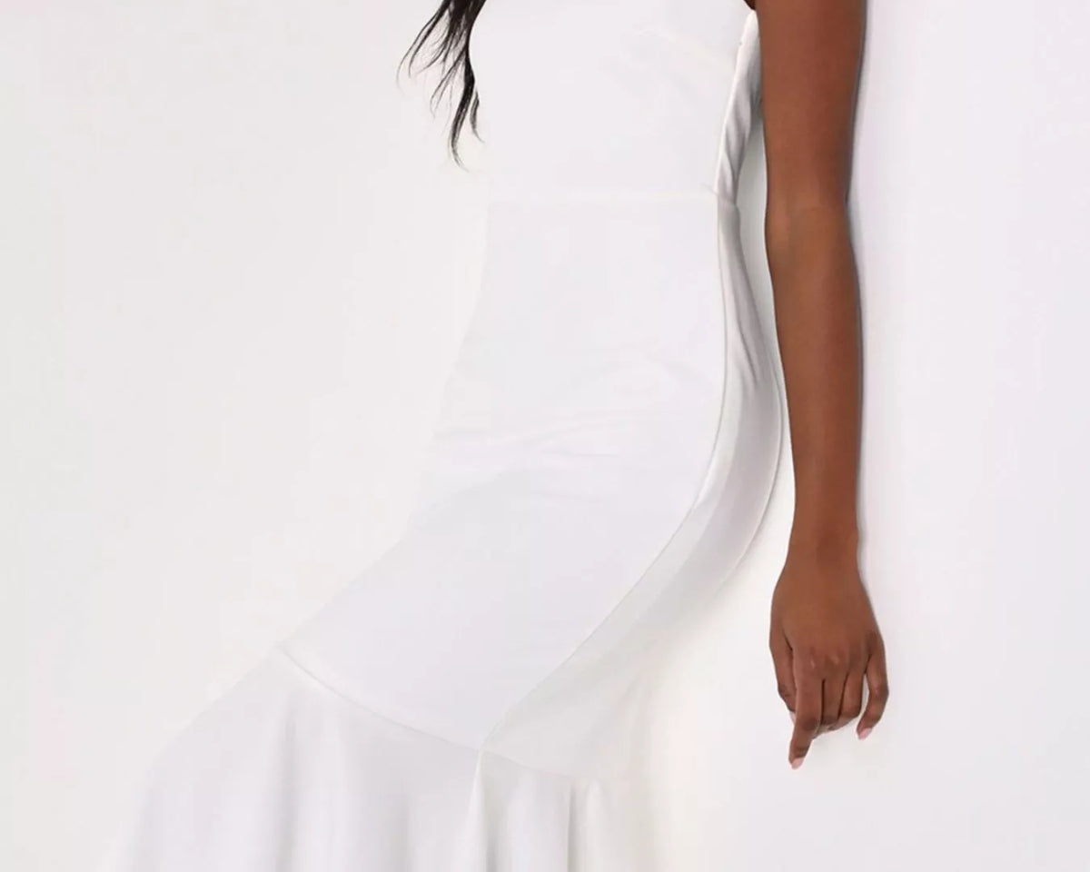 NEWYORKLISTED STYLE COLLECTION: A woman wearing a white sleeveless midi dress with a square neckline, fitted silhouette, and flared ruffled hem, posed against a plain white background.