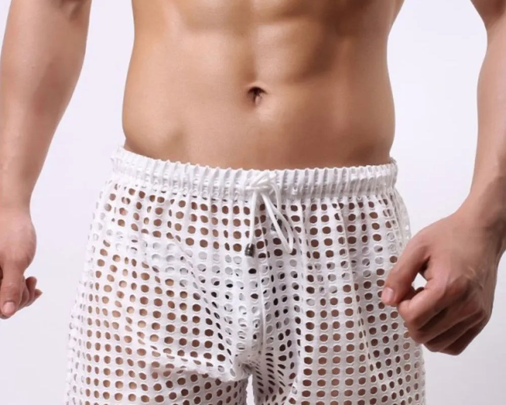 NEWYORKLISTED ATLAS MEN'S COLLECTION: Man wearing white mesh underwear on a plain background