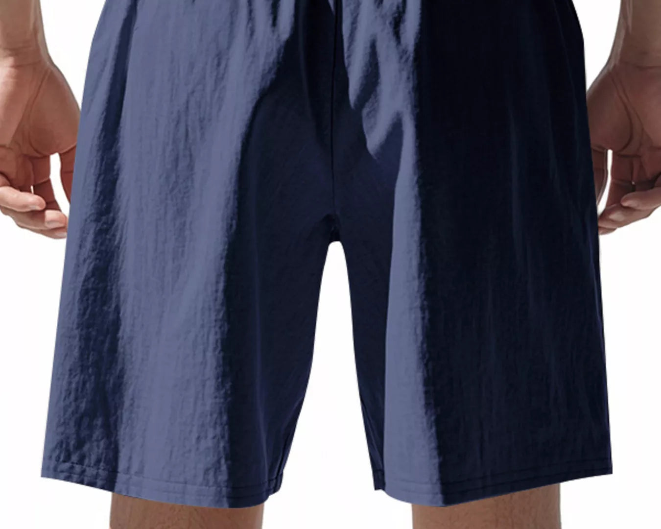 Navy blue shorts worn by a person on a white background