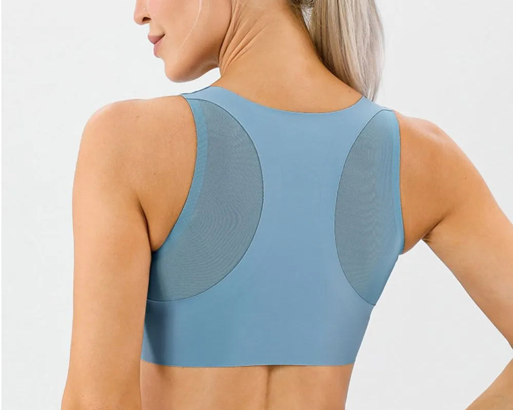 NEWYORKLISTED ACTIVEWEAR COLLECTION: Woman wearing a blue athletic top and leggings on a light gray background