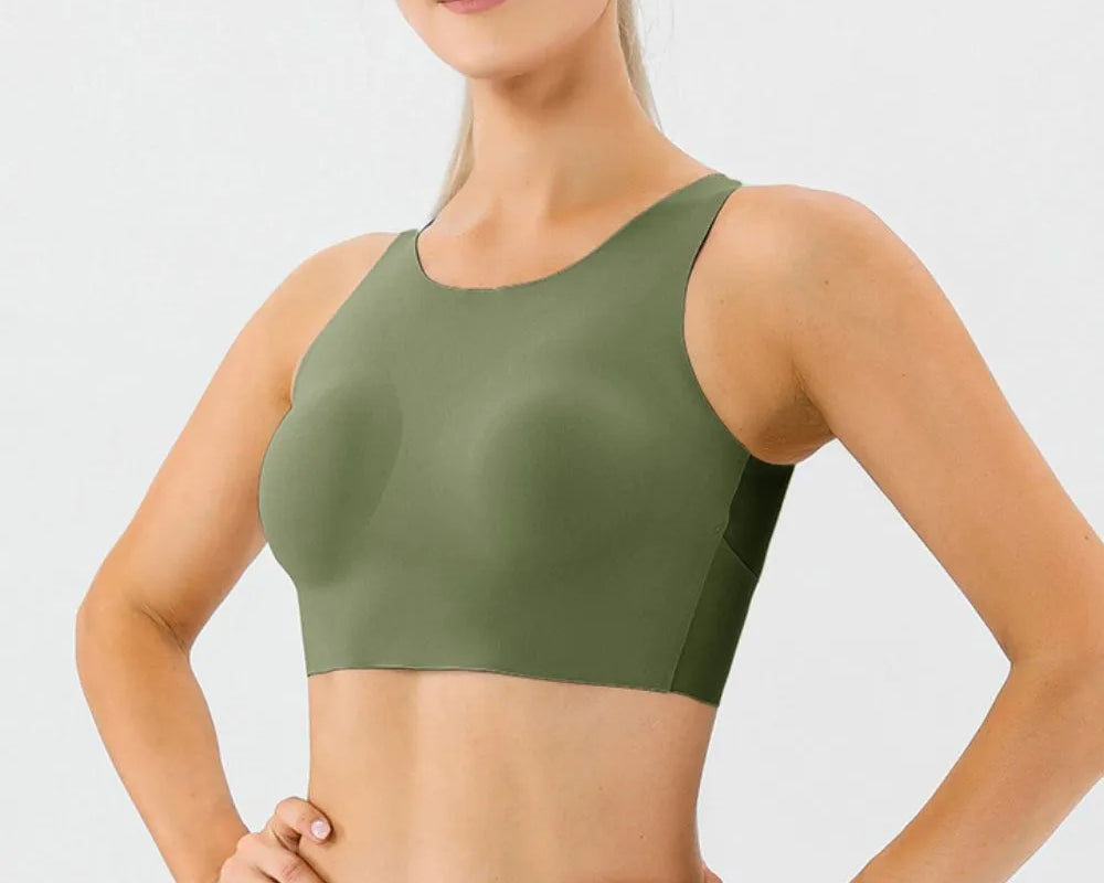 NEWYORKLISTED ACTIVEWEAR COLLECTION: Woman wearing a green sports bra and leggings on a light gray background