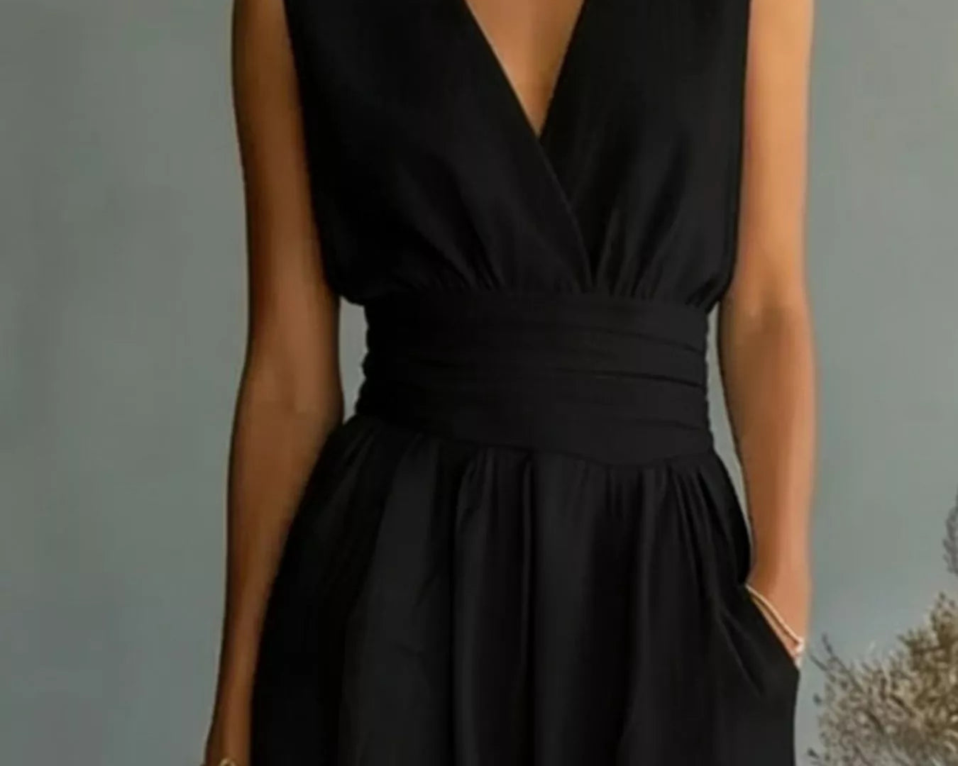 NEWYORKLISTED STYLE COLLECTION: Black sleeveless dress worn by a person against a neutral background