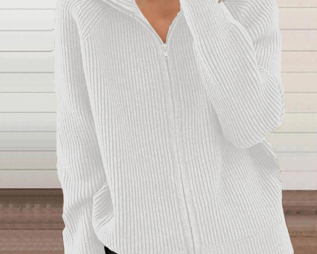 NEWYORKLISTED STYLE COLLECTION: White ribbed sweater worn by a person with a neutral background