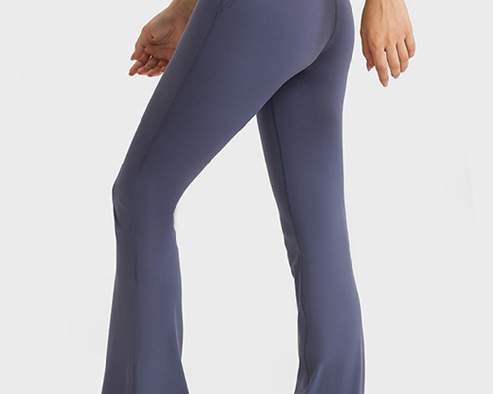 NEWYORKLISTED ACTIVEWEAR COLLECTION: Person wearing dark gray flared pants on a white background