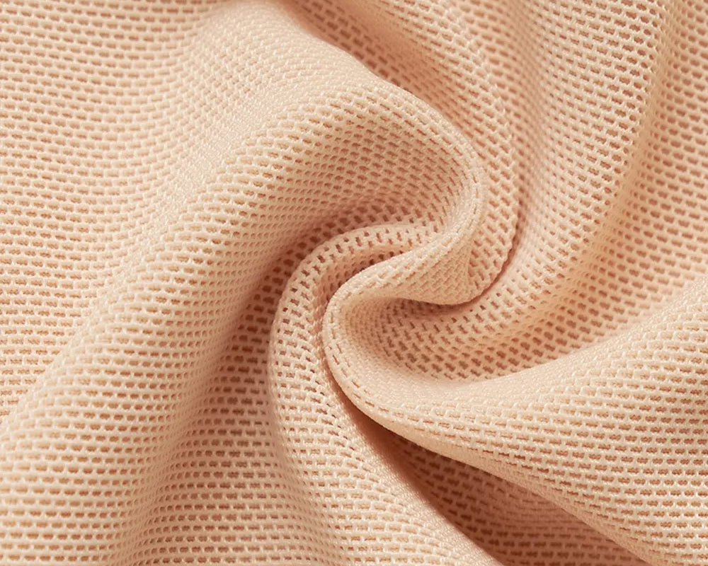 NEWYORKLISTED Intimate Apparel: Close-up of beige fabric with a textured pattern