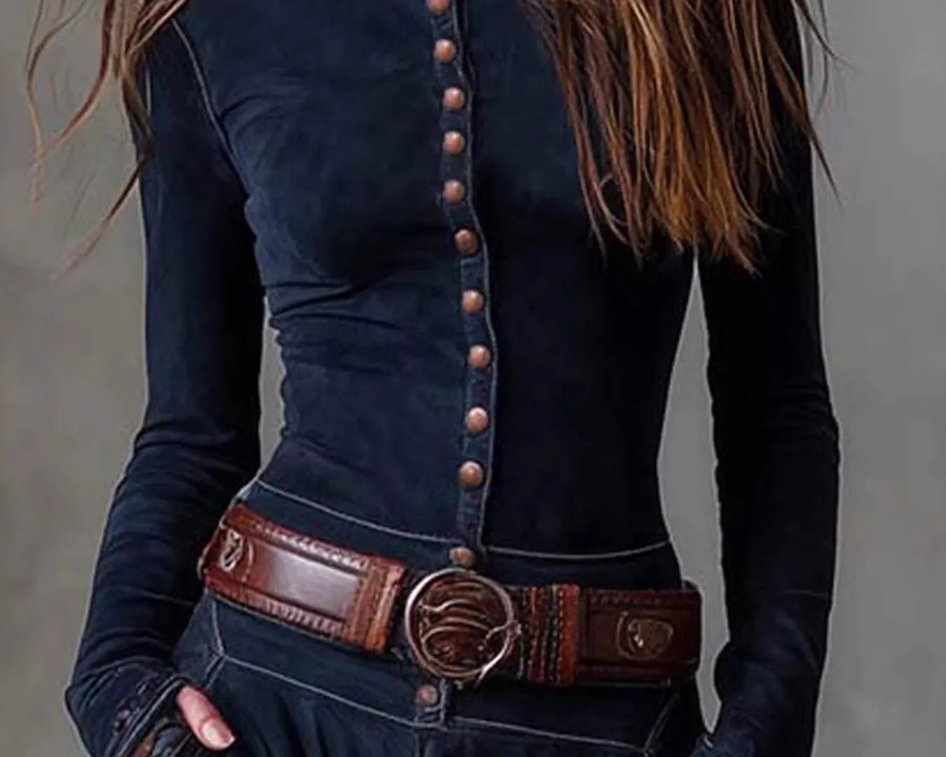 NEWYORKLISTED Style Collection: Person wearing a dark blue long-sleeve top with button details and a brown belt against a gray background