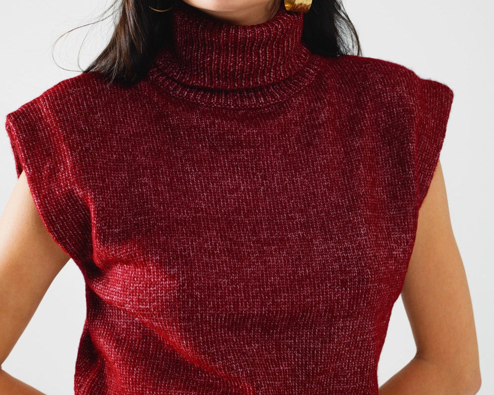 NEWYORKLISTED STYLE COLLECTION: Woman wearing a red sleeveless sweater, beige hat, and leopard print skirt against a white background