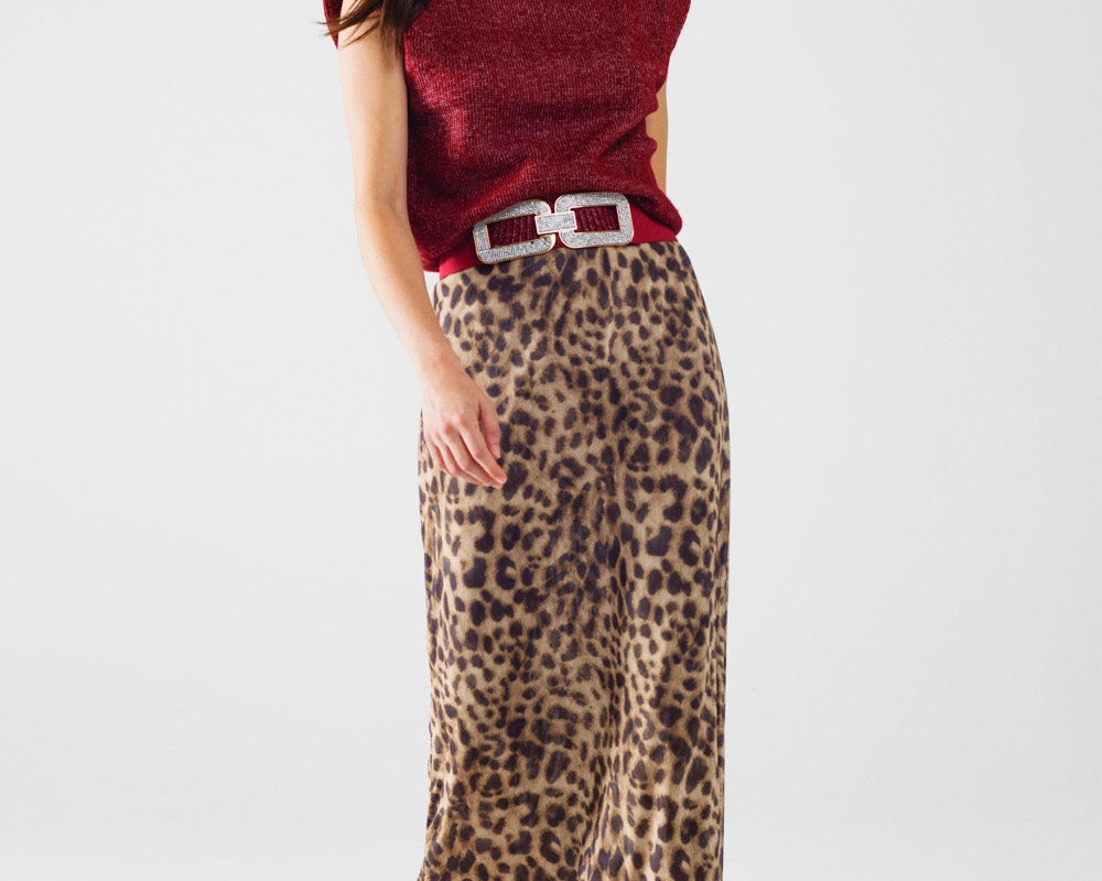 Woman wearing a red sleeveless top, leopard print skirt, red boots, and a brown hat on a white background