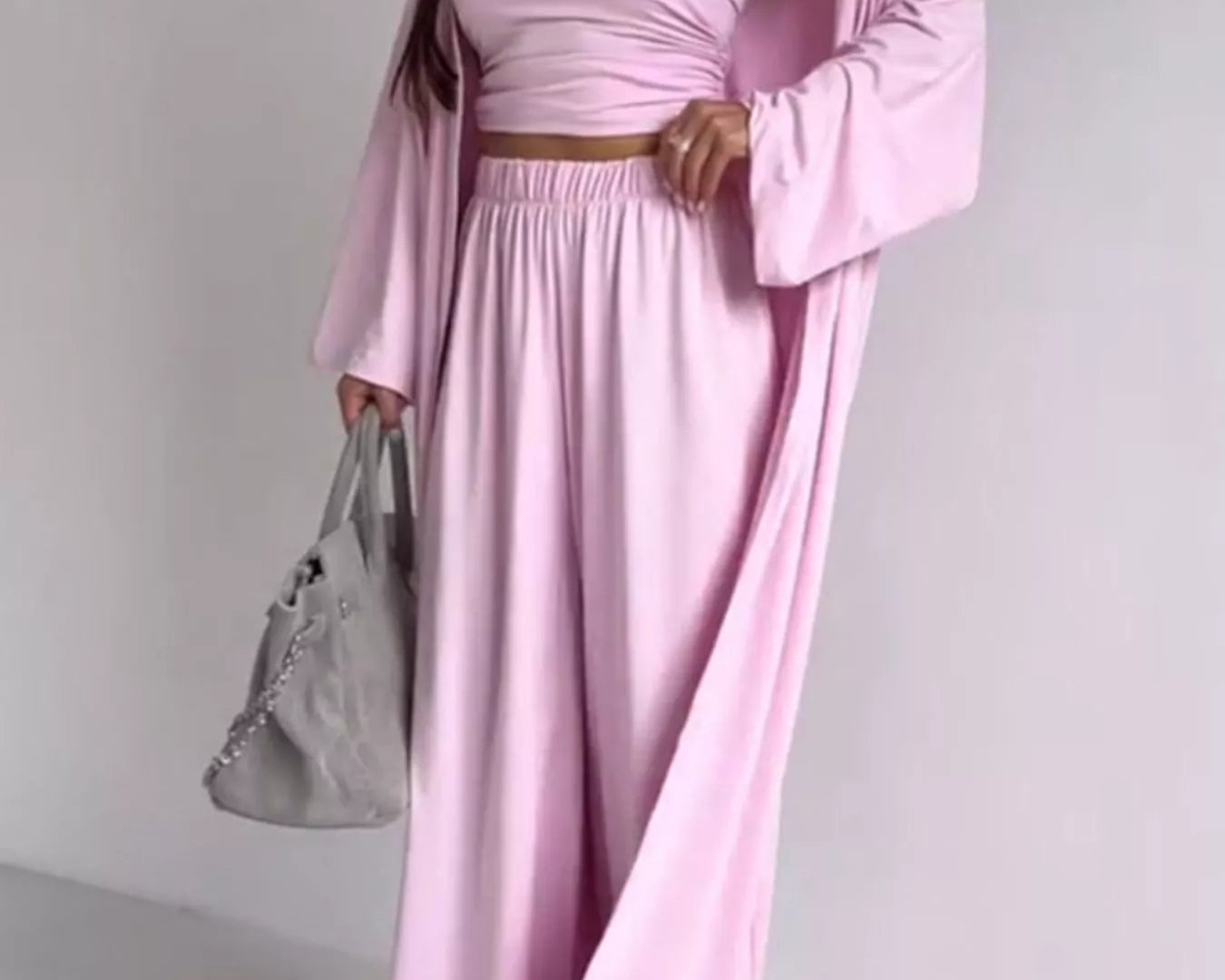 NEWYORKLISTED COMFORT COLLECTION: Woman wearing a pink dress with a matching jacket against a white background