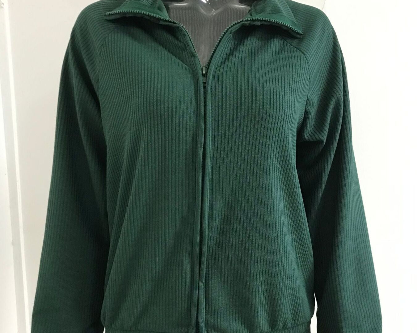 NEWYORKLISTED STYLE COLLECTION: Green jacket on a mannequin against a white background