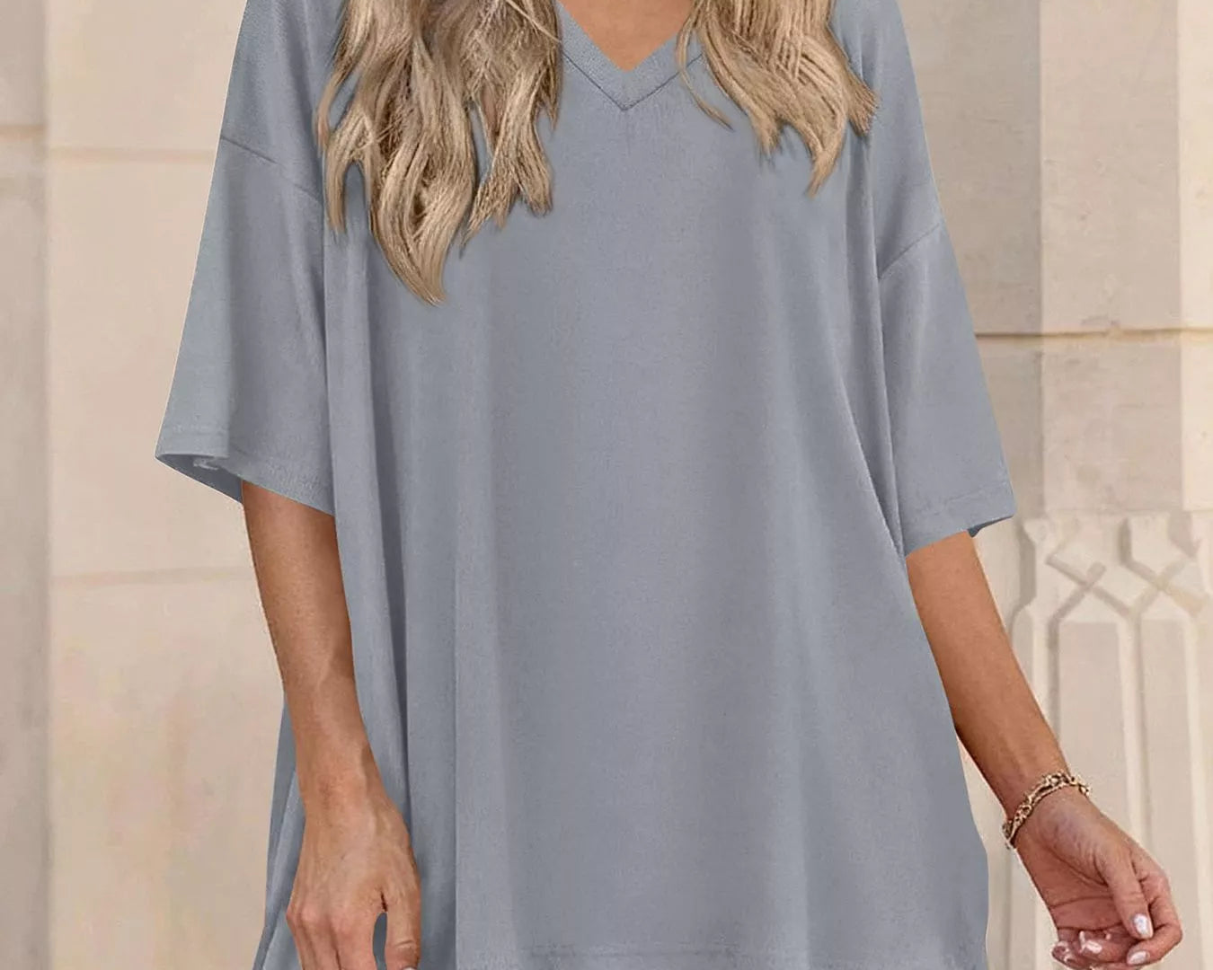 NEWYORKLISTED COMFORT COLLECTION: Woman wearing a gray oversized t-shirt and shorts set against a neutral background