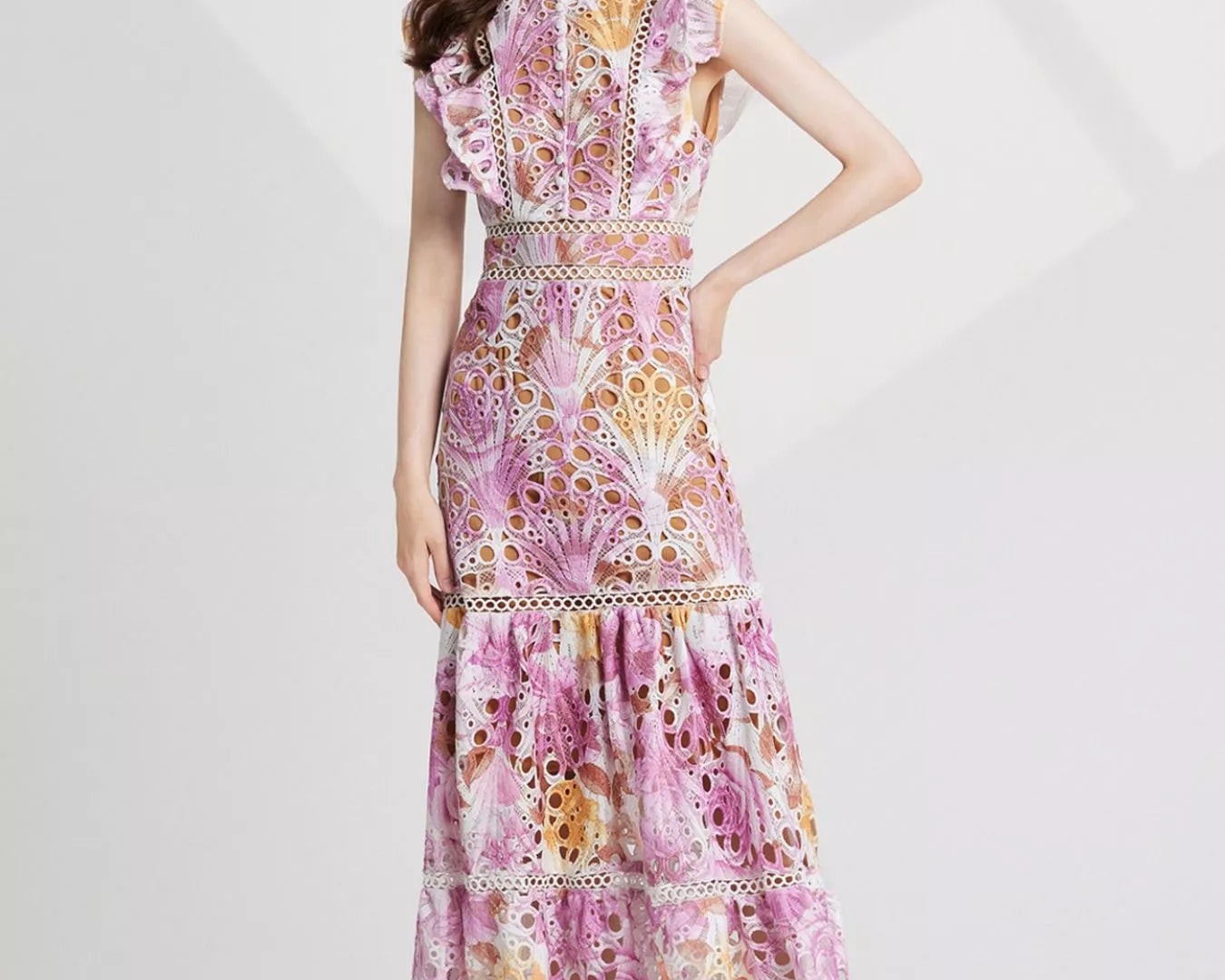 NEWYORKLISTED STYLE COLLECTION: Woman wearing a floral dress on a white background