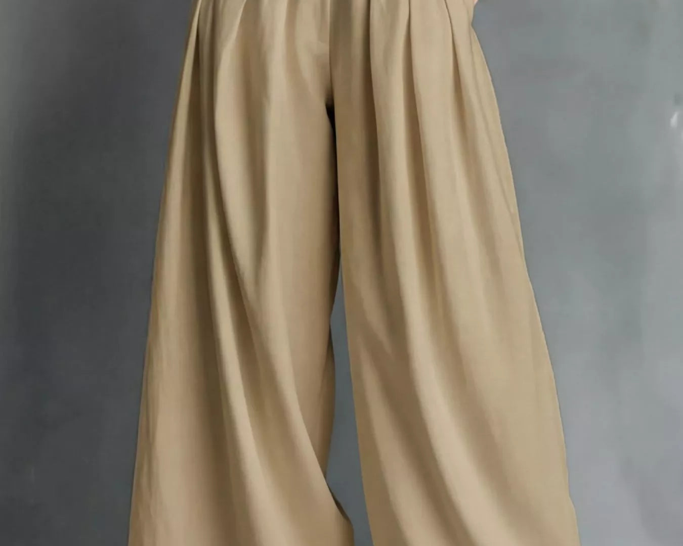 Beige wide-leg pants with a white belt on a gray background