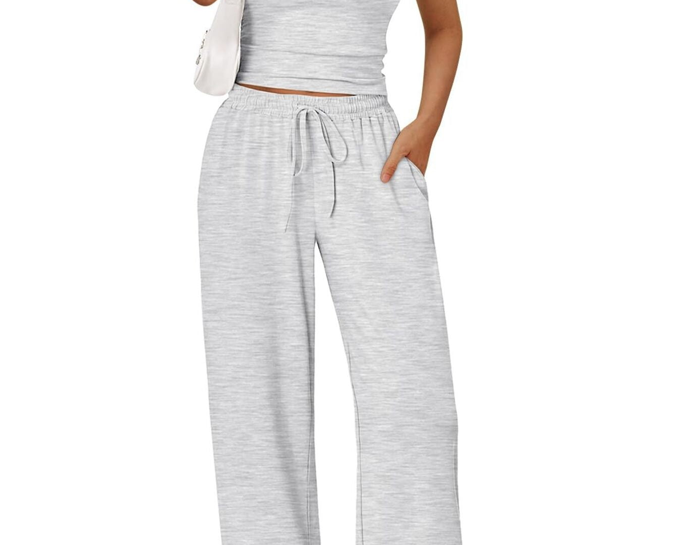 NEWYORKLISTED COMFORT COLLECTION: Woman wearing a gray crop top and wide-leg pants on a white background