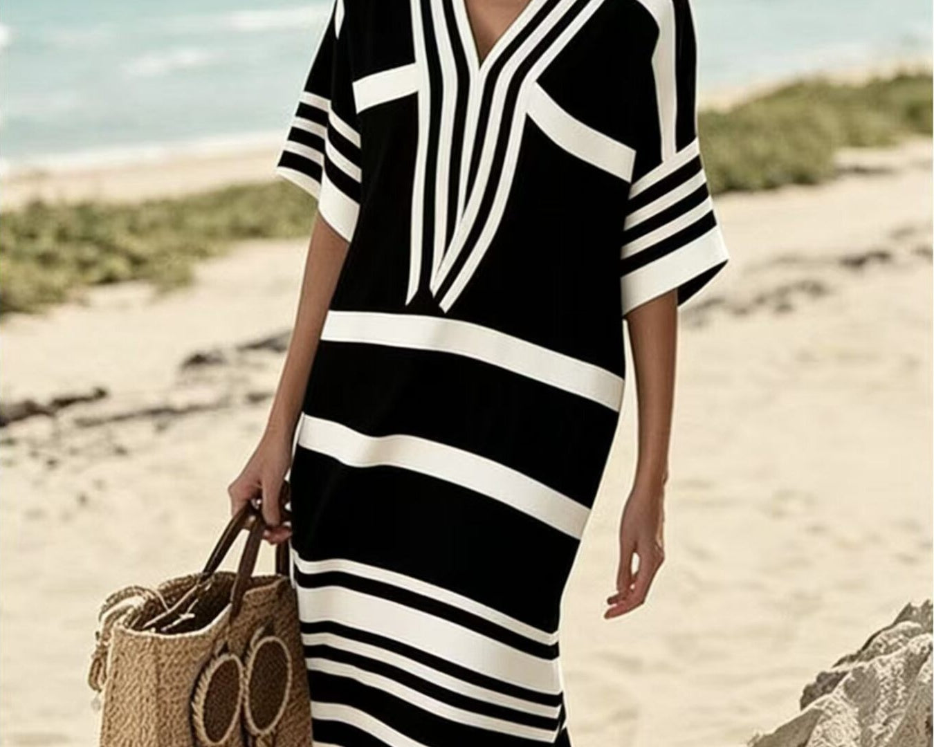 NEWYORKLISTED STYLE COLLECTION: Woman in a black and white striped dress on a beach
