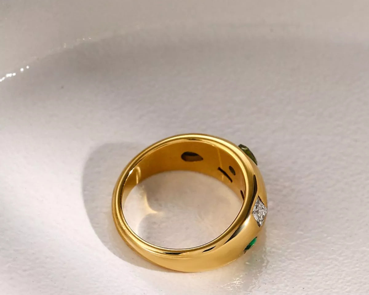 NYLD Glamour Collection by NEWYORKLISTED: Gold ring with gemstones on a white background