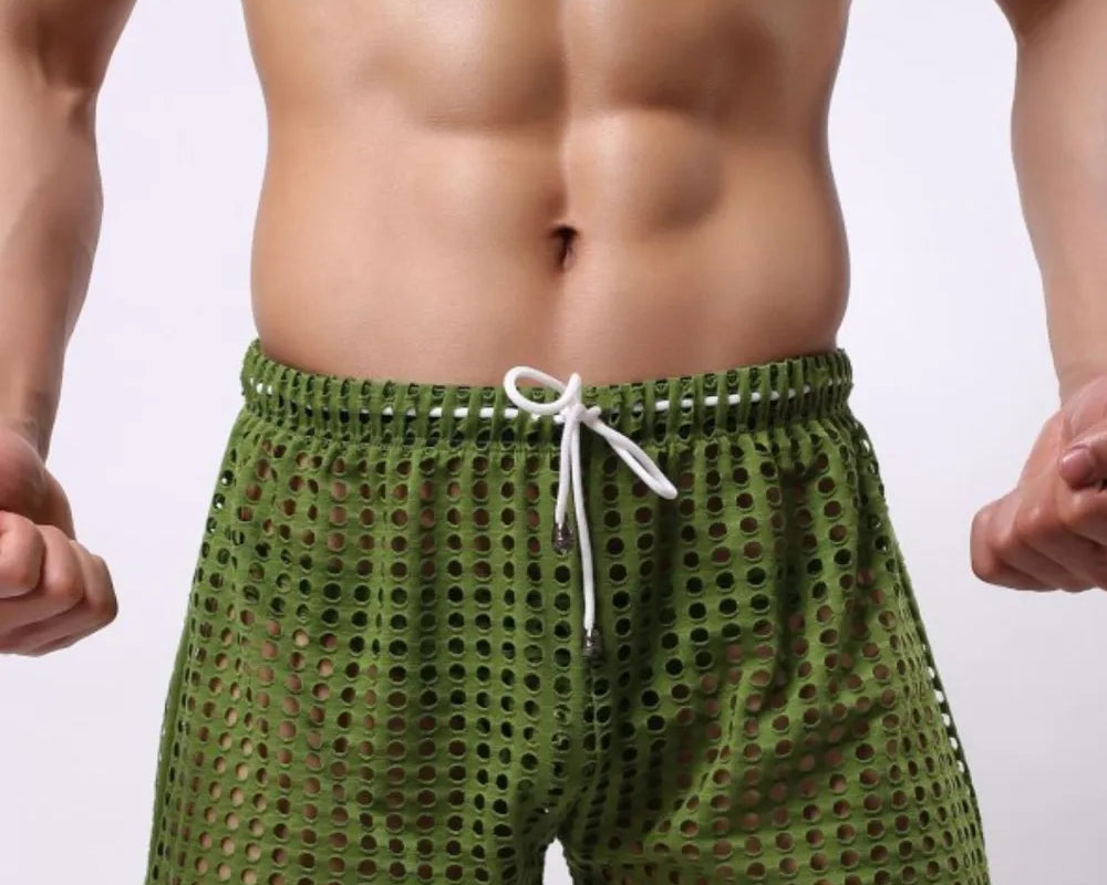 NEWYORKLISTED ATLAS MEN'S COLLECTION: Green swim shorts worn by a person on a plain background