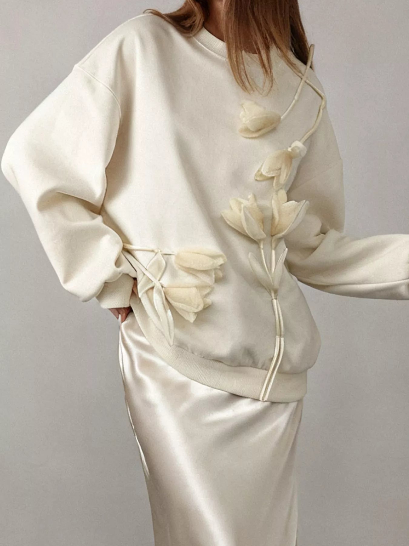NEWYORKLISTED STYLE COLLECTION: White outfit with floral details on a plain background