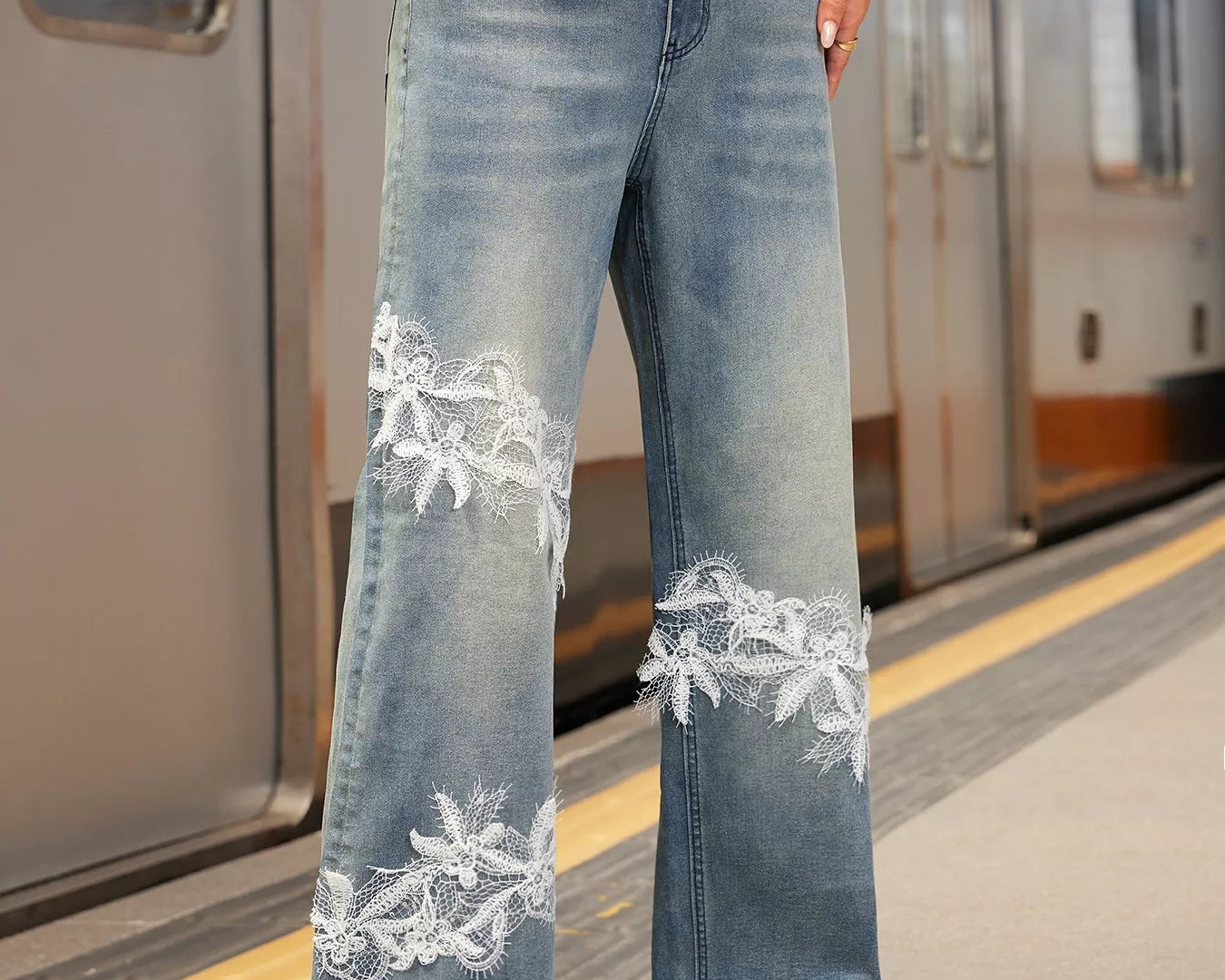 NEWYORKLISTED STYLE COLLECTION: Person wearing blue jeans with lace detailing on a subway platform