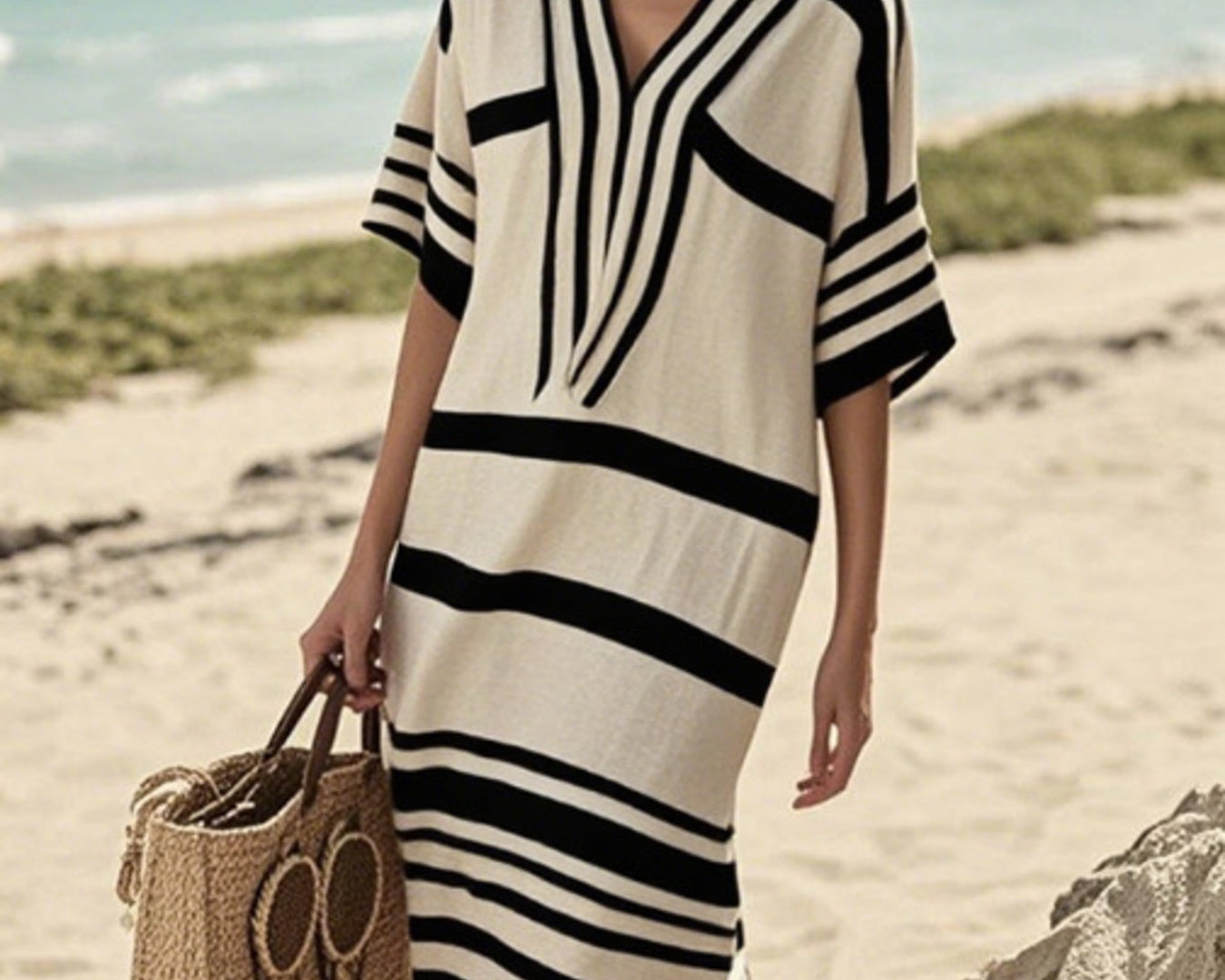 NEWYORKLISTED STYLE COLLECTION: Woman in a black and white striped dress on a beach
