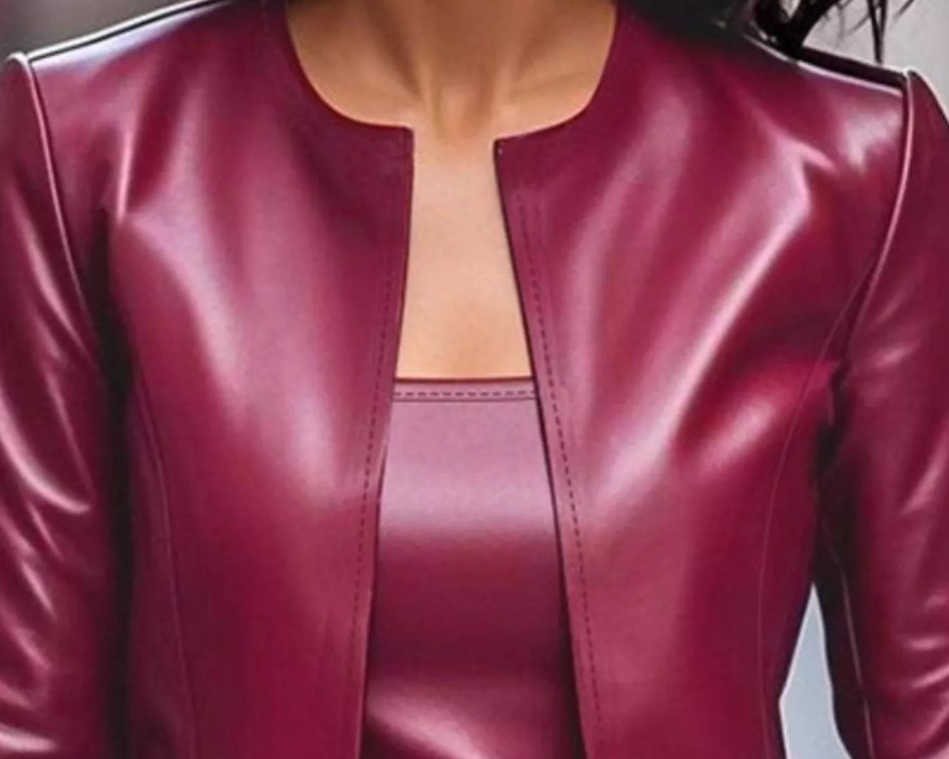 NEWYORKLISTED STYLE COLLECTION: Close-up of a person wearing a burgundy leather jacket.