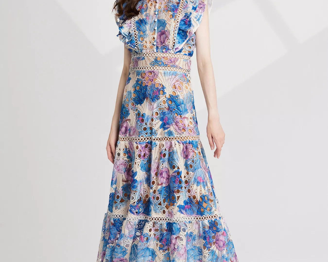 NEWYORKLISTED STYLE COLLECTION: Woman wearing a floral dress on a white background