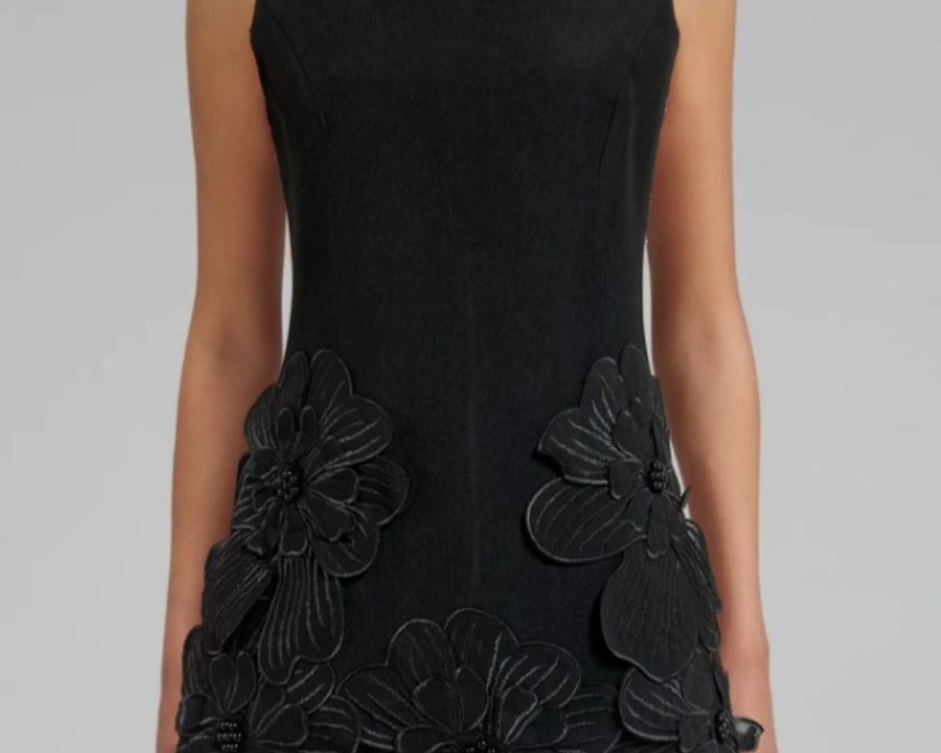 NEWYORKLISTED STYLE COLLECTION: Black dress with floral embellishments on a gray background