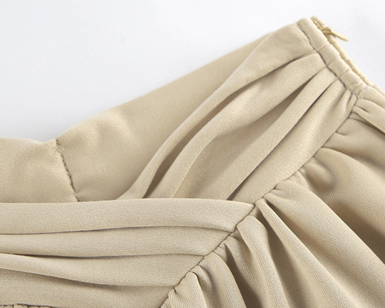 NEWYORKLISTED STYLE COLLECTION: Close-up of beige fabric with a white background