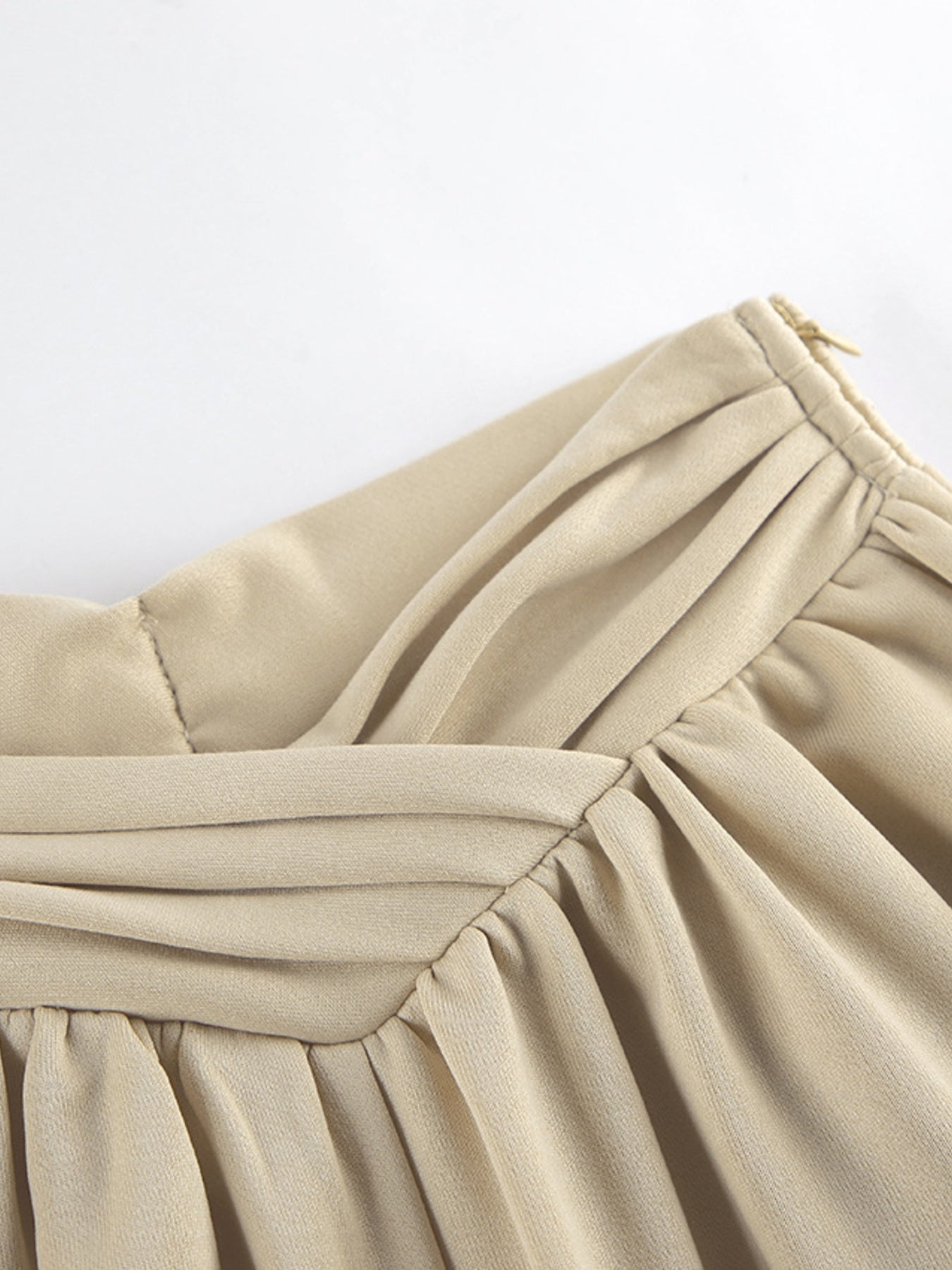 NEWYORKLISTED STYLE COLLECTION: Close-up of beige fabric with a white background
