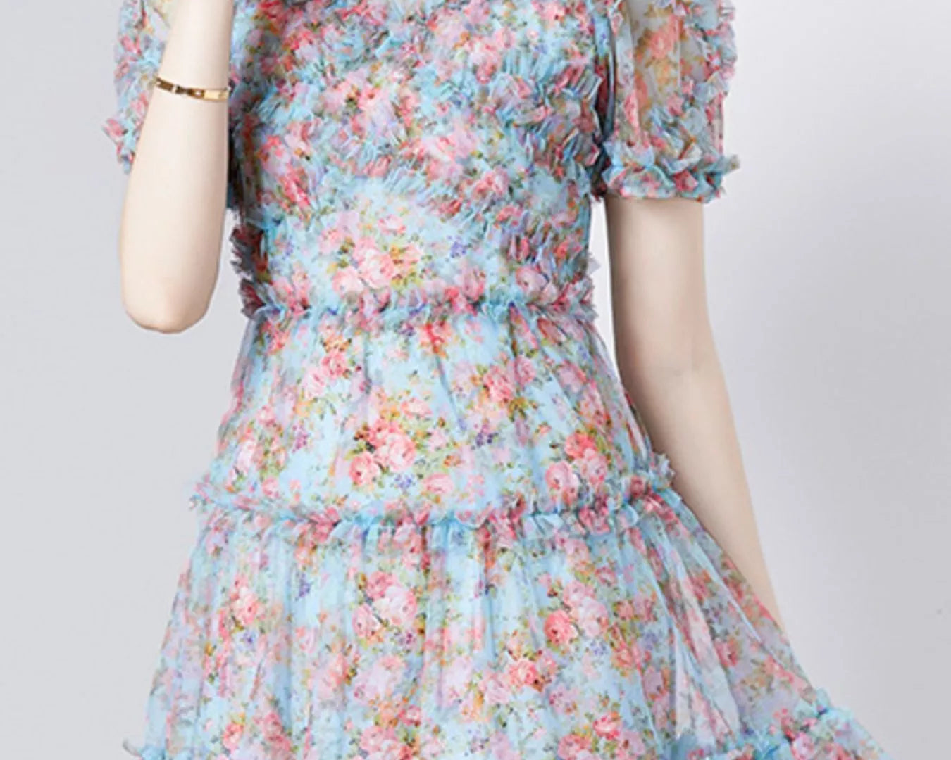 NEWYORKLISTED STYLE COLLECTION: Woman wearing a floral dress with a plain background