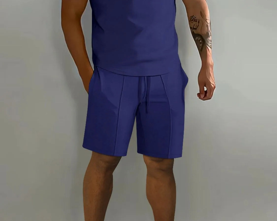 NEWYORKLISTED ATLAS MEN's COLLECTION: Person wearing a blue outfit with a polo shirt and shorts on a gray background