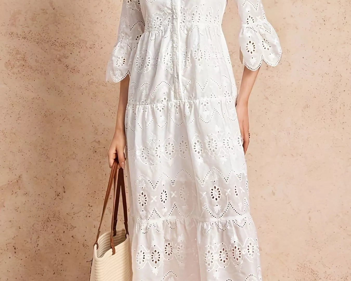 NEWYORKLISTED STYLE COLLLECTION: Woman wearing a white lace dress against a beige background
